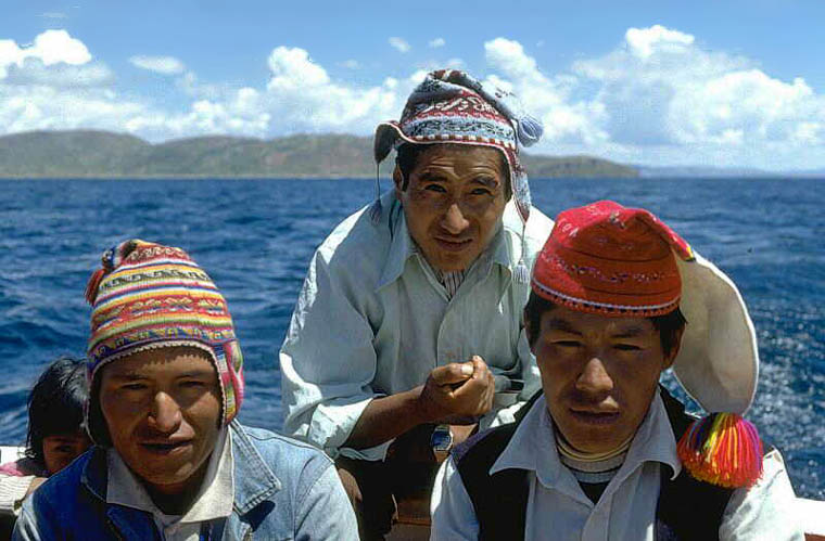 Helmsman and his assistants on the boat from the Isle of Taquile to Puno, Lake Titicaca, Peru
